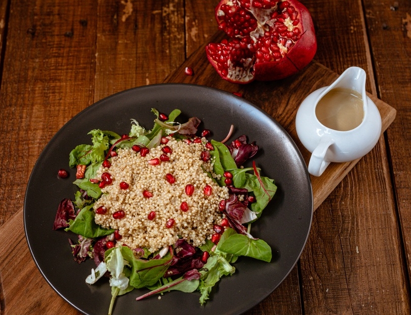 Vegan salad with millet and pomegranate, tahini dressing