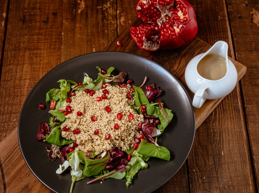 Vegan salad with millet and pomegranate, tahini dressing